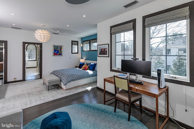 bedroom with wood finished floors, recessed lighting, visible vents, and baseboards