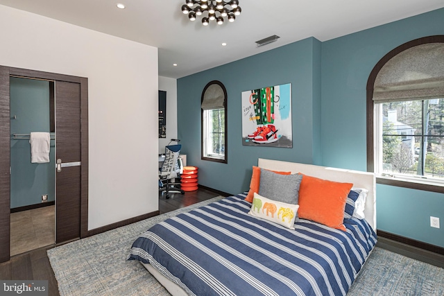 bedroom featuring visible vents, recessed lighting, baseboards, and wood finished floors