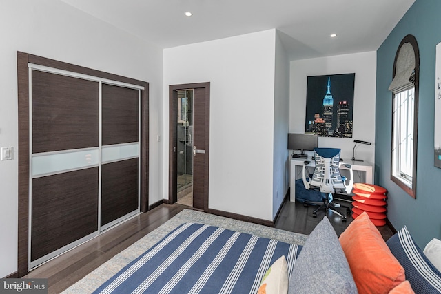 bedroom with recessed lighting, baseboards, and wood finished floors