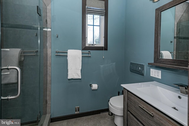 bathroom featuring a stall shower, toilet, and vanity