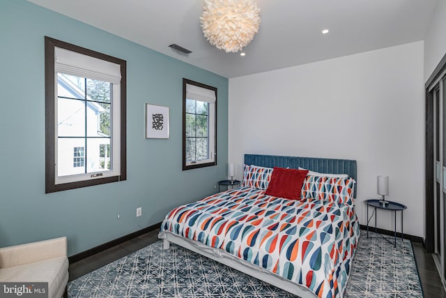 bedroom featuring recessed lighting, multiple windows, baseboards, and visible vents