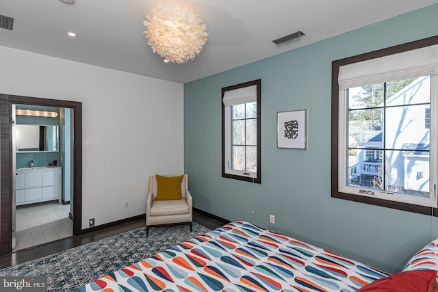 bedroom with visible vents, multiple windows, and baseboards