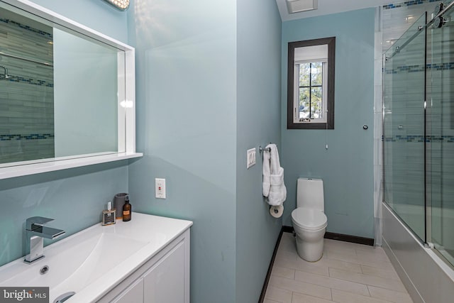 bathroom with baseboards, toilet, shower / bath combination with glass door, tile patterned floors, and vanity