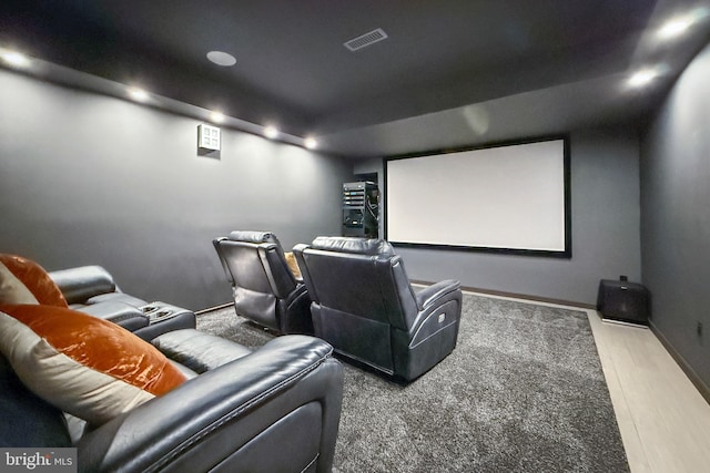 cinema with visible vents, baseboards, and wood finished floors