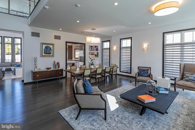 living room with recessed lighting, visible vents, and dark wood-style flooring