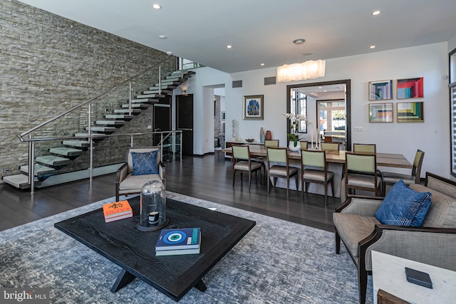 living area featuring stairs, recessed lighting, and wood finished floors