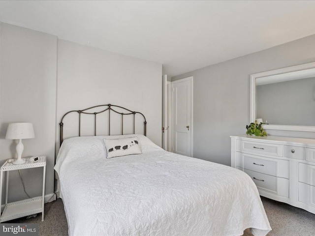 bedroom featuring dark carpet