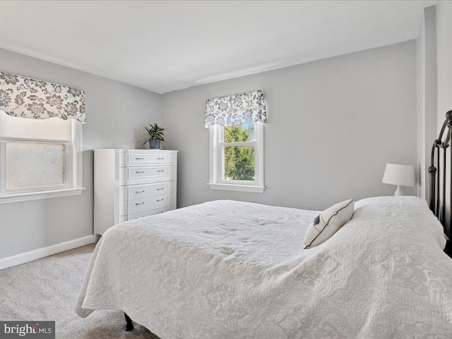 carpeted bedroom featuring baseboards