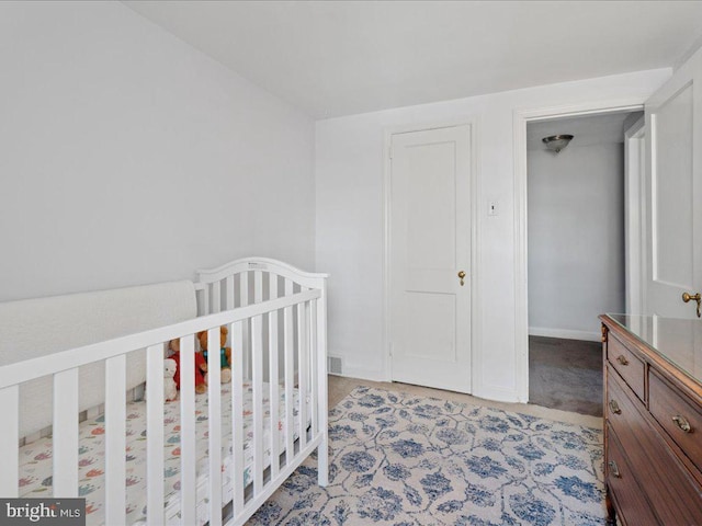 bedroom with light carpet and baseboards