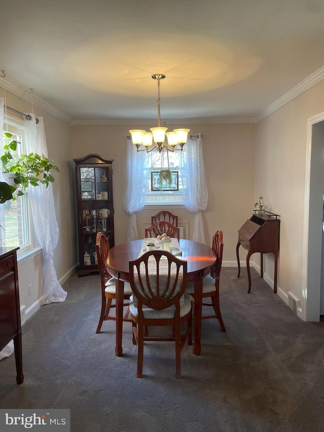 carpeted dining room featuring visible vents, baseboards, a notable chandelier, and ornamental molding