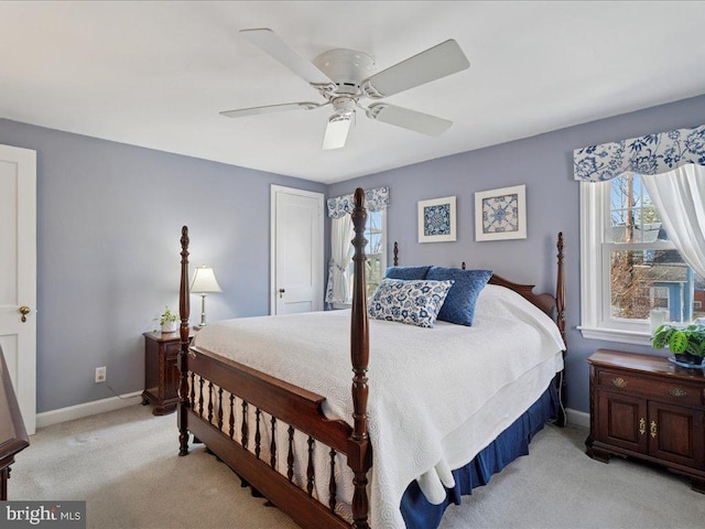 bedroom with light colored carpet, baseboards, and ceiling fan