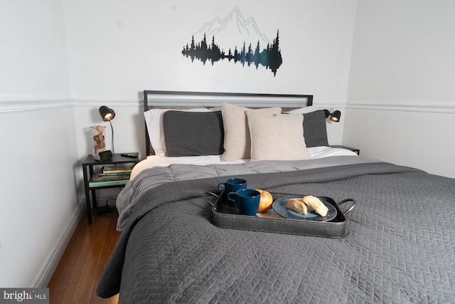 bedroom featuring wood finished floors and baseboards