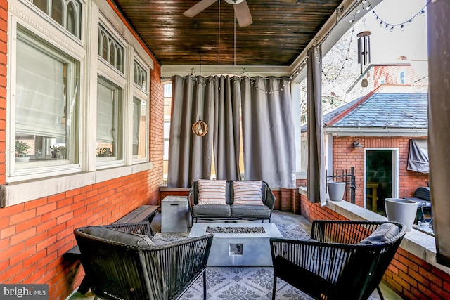 sunroom / solarium featuring wood ceiling, a wealth of natural light, and ceiling fan