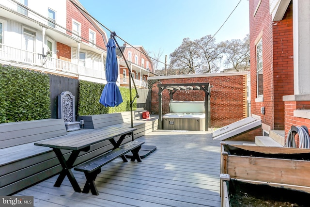 wooden terrace featuring a covered hot tub