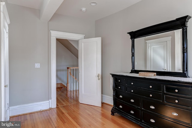 bedroom with light wood finished floors and baseboards