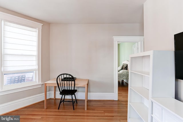 office area with baseboards and light wood-style floors