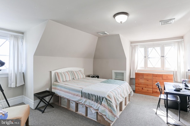 bedroom with visible vents, multiple windows, and vaulted ceiling