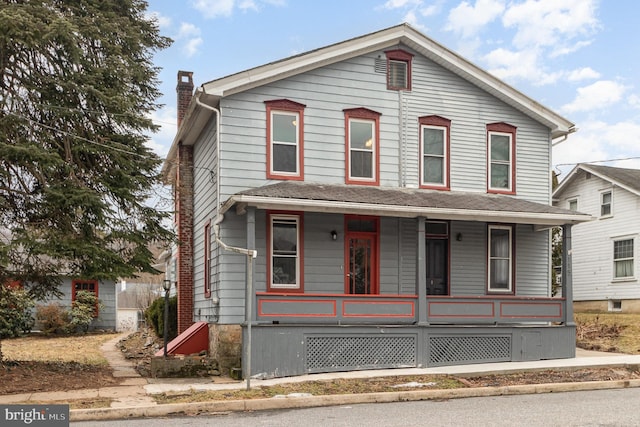 view of front of property with covered porch and a chimney