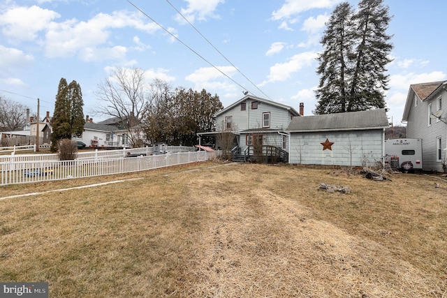 view of yard with an outbuilding and fence