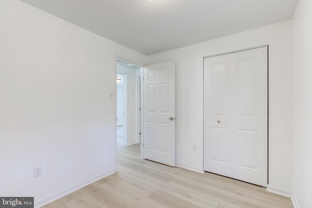 unfurnished bedroom featuring baseboards and light wood finished floors