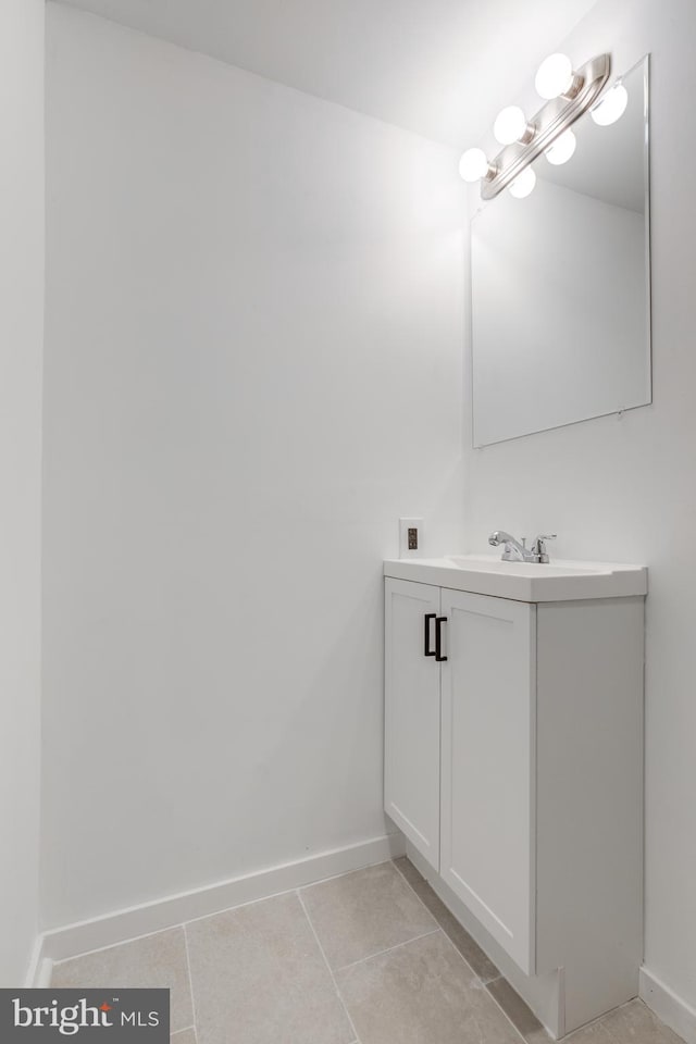 bathroom with tile patterned floors, baseboards, and vanity