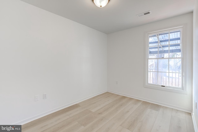 unfurnished room with visible vents, baseboards, and light wood-style floors