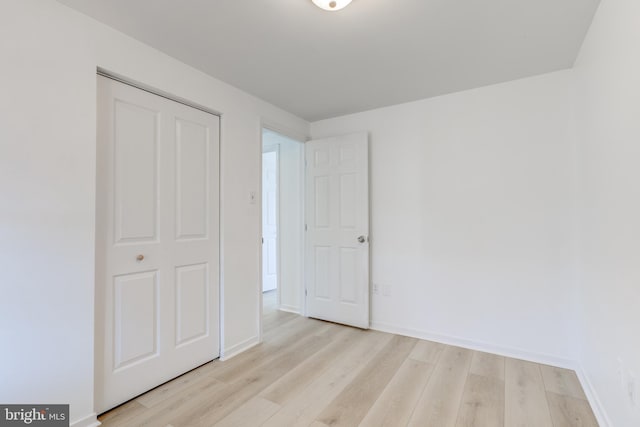 unfurnished bedroom featuring baseboards and light wood-style floors