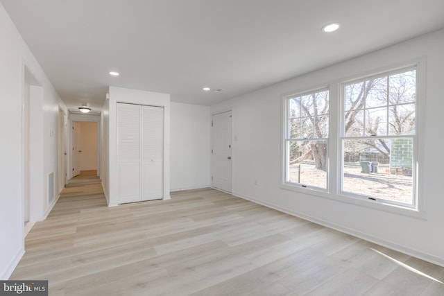 interior space featuring visible vents, recessed lighting, light wood-type flooring, and baseboards