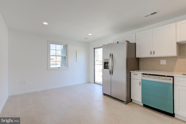 kitchen with visible vents, dishwasher, light countertops, decorative backsplash, and stainless steel fridge