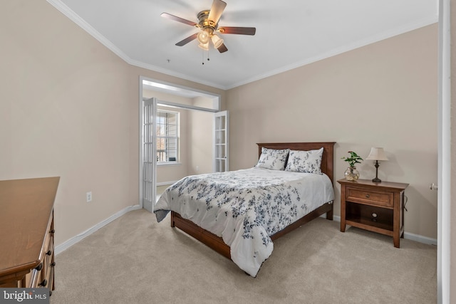 bedroom featuring a ceiling fan, crown molding, light colored carpet, and baseboards