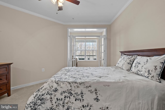 bedroom featuring light colored carpet, crown molding, baseboards, and ceiling fan