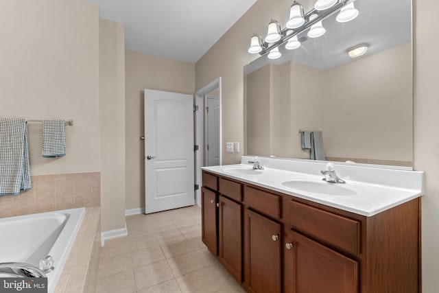 bathroom featuring a sink, tiled bath, double vanity, and tile patterned flooring