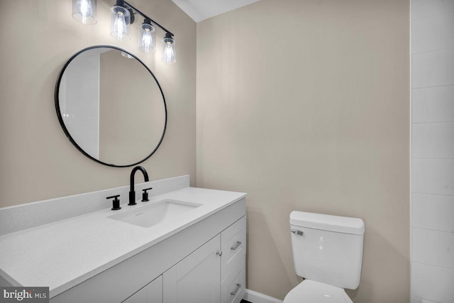 bathroom with toilet and vanity