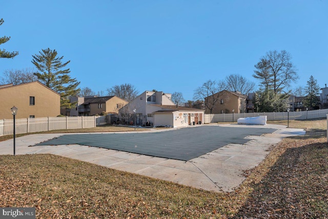 view of pool featuring a patio area, a residential view, a fenced in pool, and fence