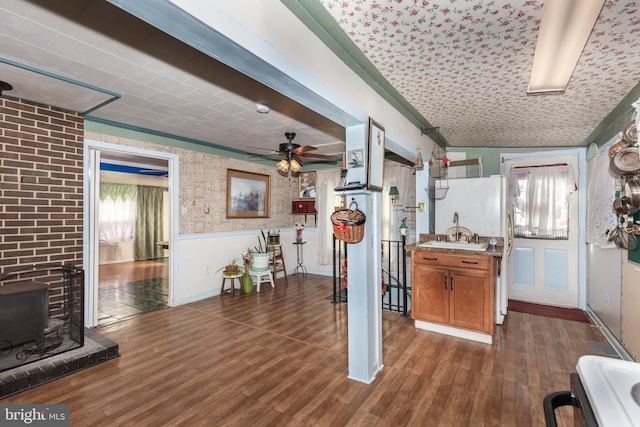 interior space with dark wood-type flooring, brown cabinetry, and a healthy amount of sunlight