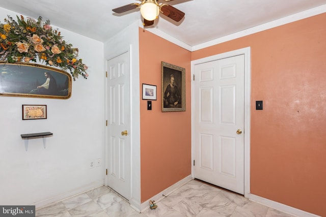 corridor featuring baseboards, marble finish floor, and ornamental molding