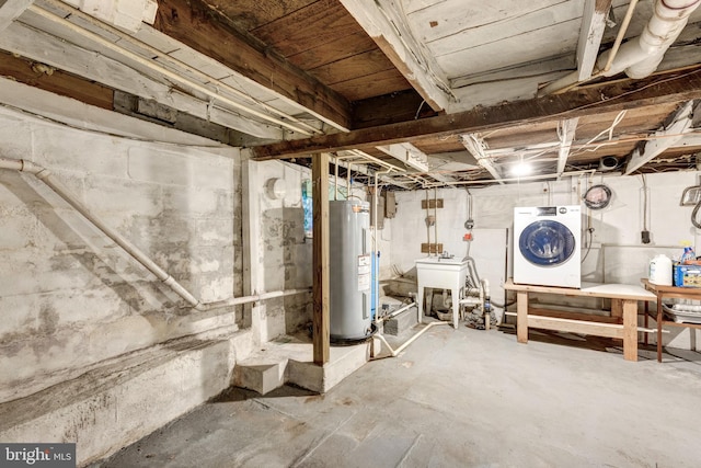 unfinished basement with washer / clothes dryer, electric water heater, and a sink