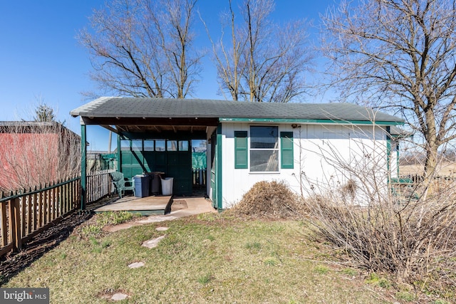 exterior space with an outdoor structure, a yard, and fence