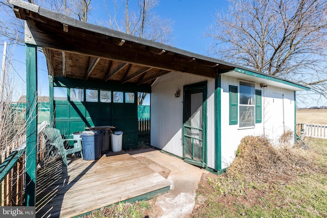 view of patio with an outdoor structure and fence