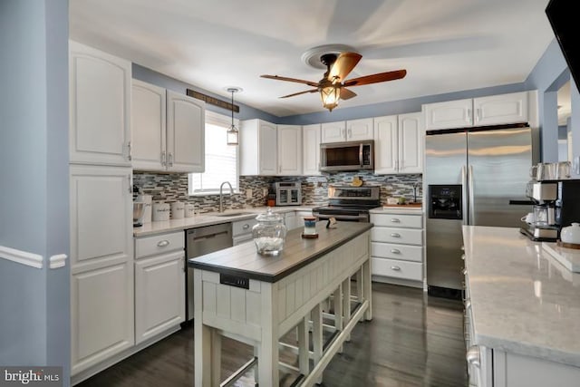 kitchen featuring backsplash, white cabinets, and appliances with stainless steel finishes