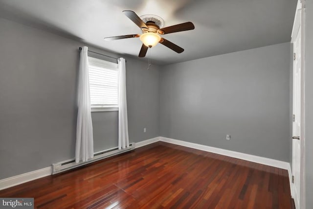 spare room with a baseboard radiator, baseboards, dark wood-style floors, and a ceiling fan