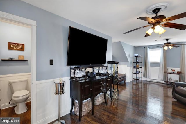 living room featuring wood finished floors and a wainscoted wall