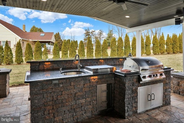 view of patio / terrace featuring a sink, an outdoor kitchen, a grill, and ceiling fan