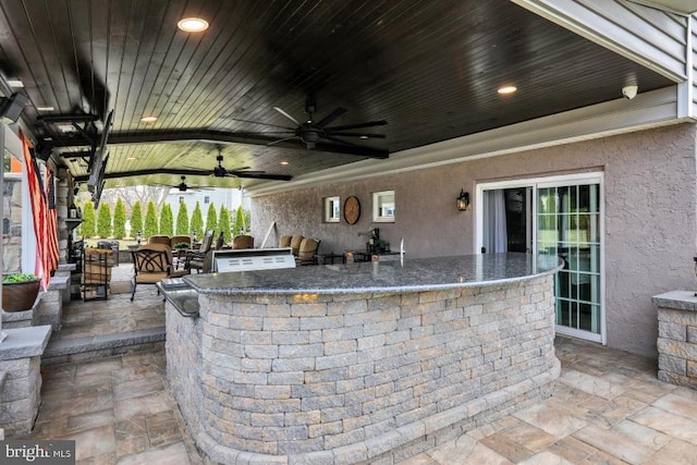 view of patio featuring area for grilling and ceiling fan