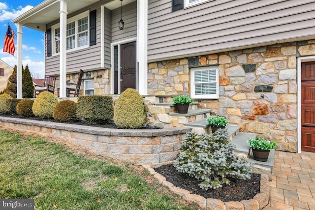 doorway to property with stone siding