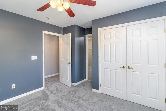 unfurnished bedroom with a closet, baseboards, carpet floors, and ceiling fan