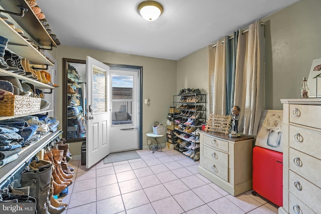 spacious closet with light tile patterned floors