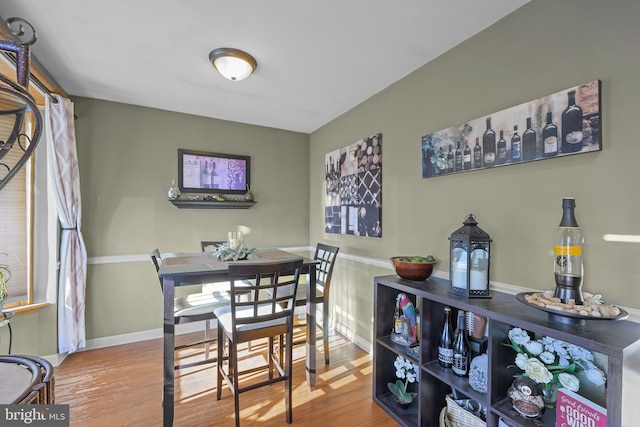 dining room with baseboards and wood finished floors