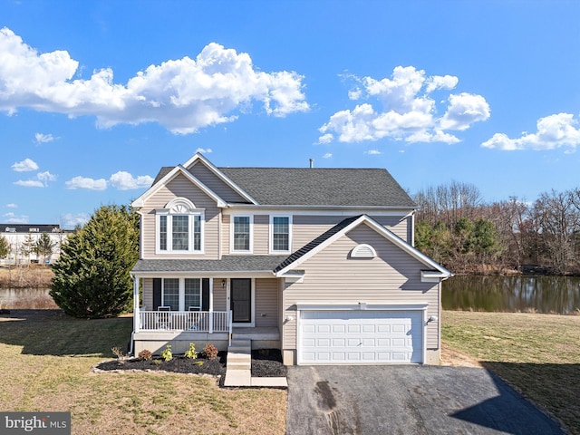 traditional home featuring aphalt driveway, a garage, covered porch, and a front lawn