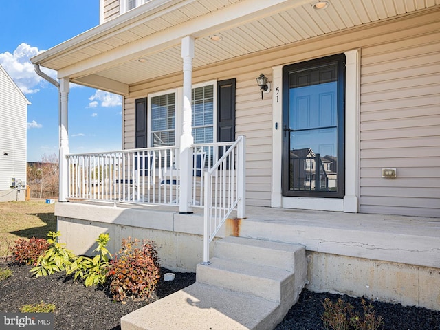 view of exterior entry featuring a porch